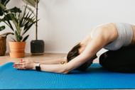 Child's pose helps release tight and painful back muscles. (Photo via Pexels/Karolina Grabowska)